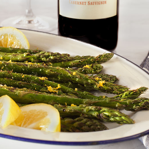 Grilled Asparagus with lemon butter on a plate paired with cabernet