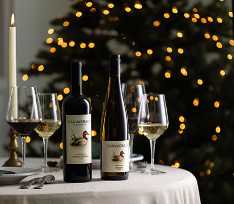 Canvasback wines on the table with Christmas tree in background