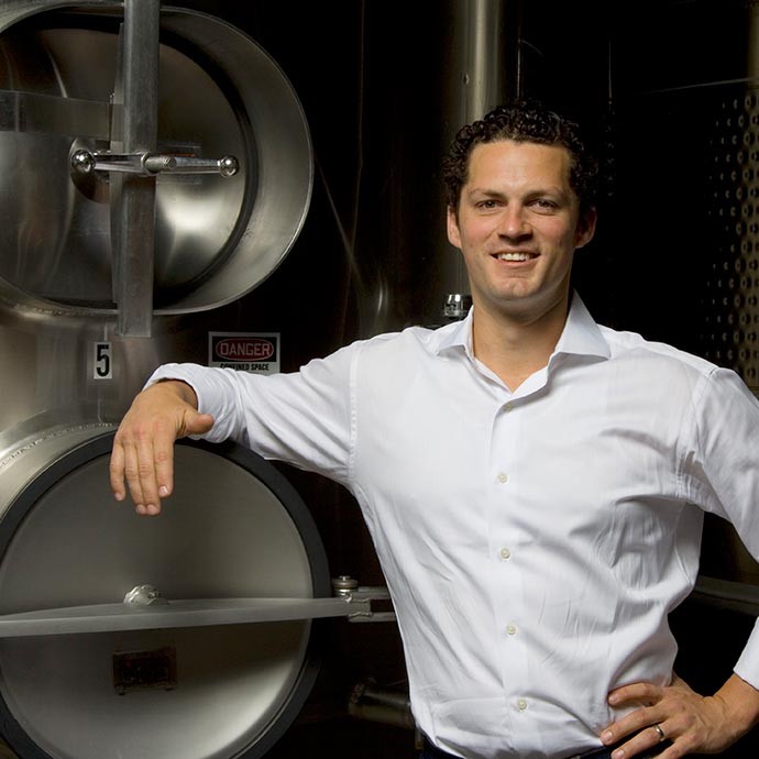 Winemaker Brian Rudin in front of fermentation tank