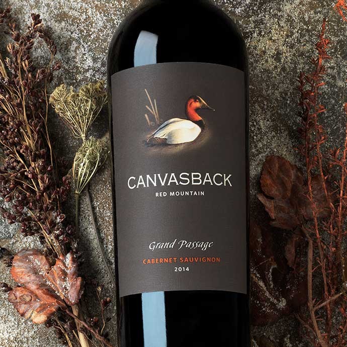 Bottle of Grand Passage with fall foliage background