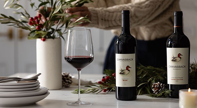 Person using foil cutter on Canvasback wine bottle