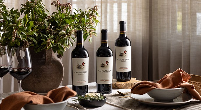 Person using foil cutter on Canvasback wine bottle