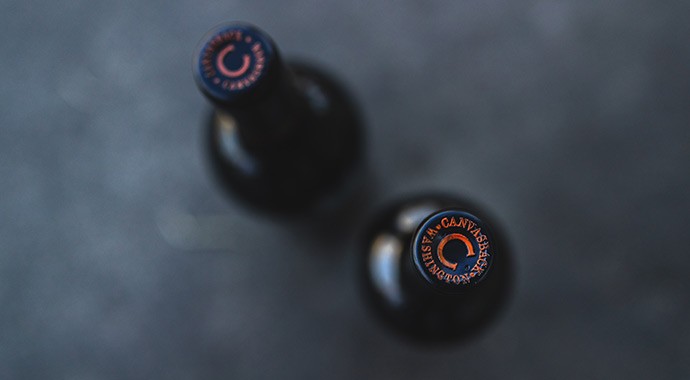 Two Canvasback wines shot from above prominent C on foil