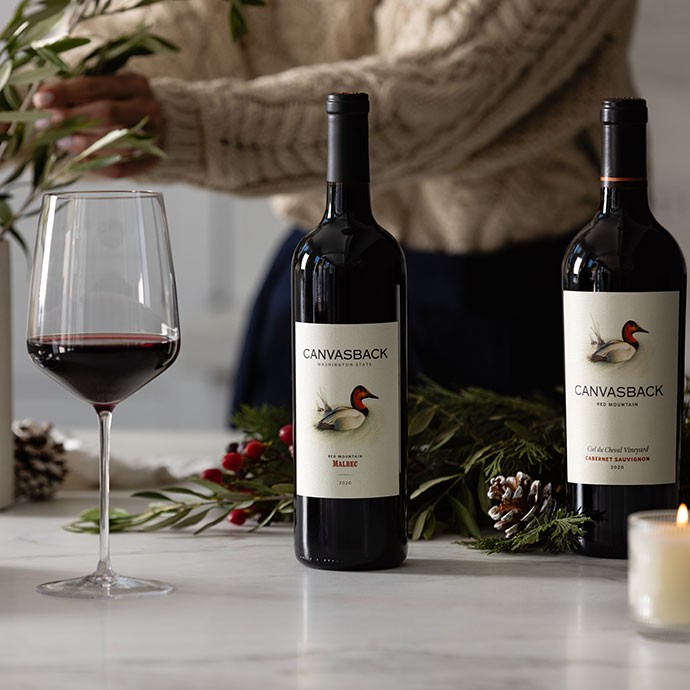 Canvasback wines on the table with bowls of soup