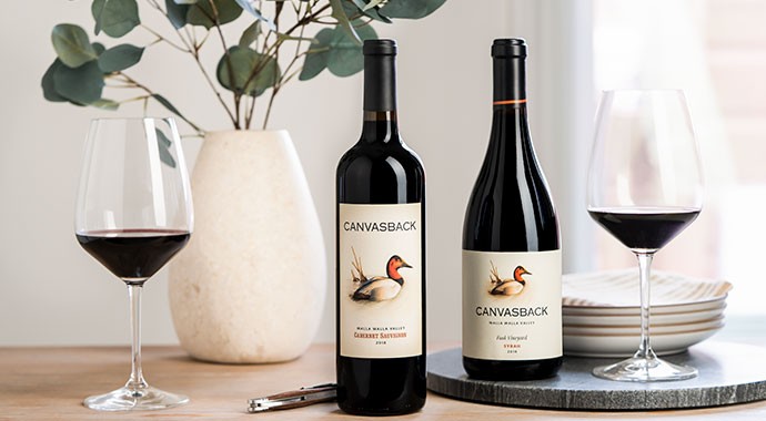 Two Canvasback wines with plates and two wine glasses